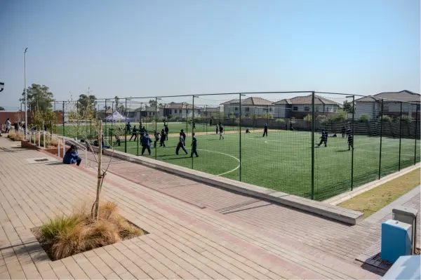 The astro sports field beside a paved walkway