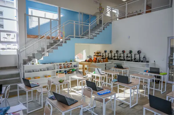 The double-volume Design and Technology Lab with laptops and a staircase