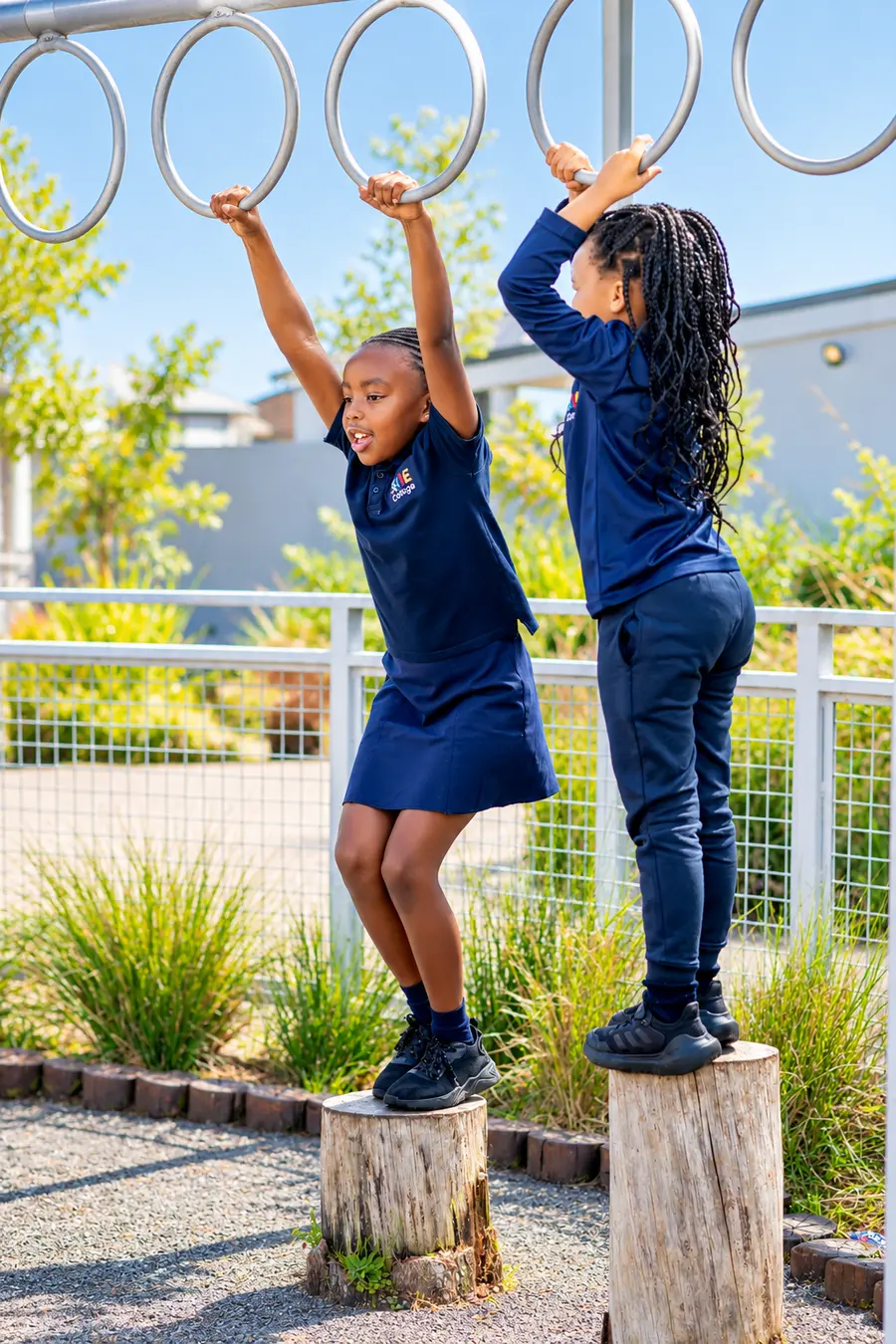 Two Prep girls reaching for the monkey bars